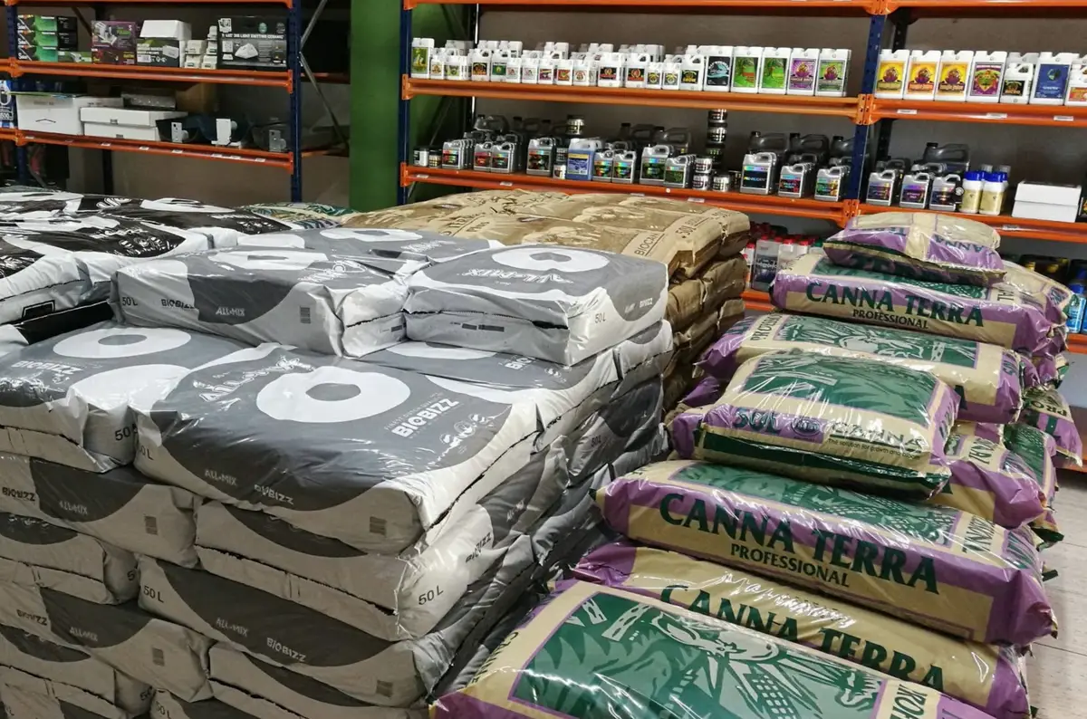 Inside the Optigarden grow shop, with pallets of soil bags and shelves full of fertilizer